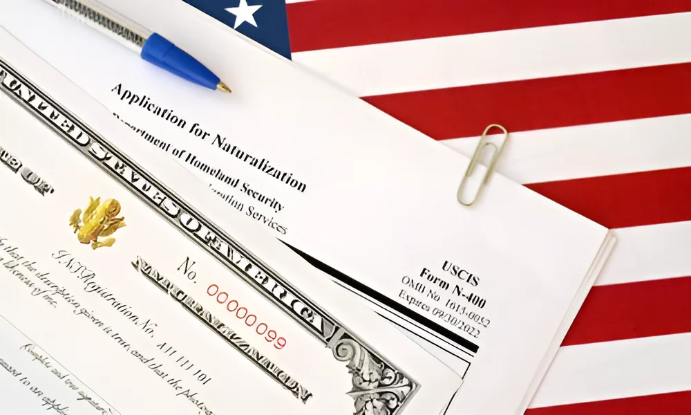 A copy of the Form N-400 visa application on a table with an American flag print.