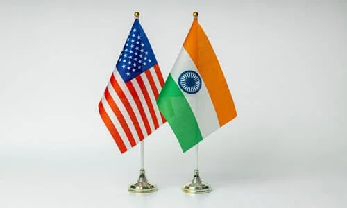 A pair of American and Indian tabletop flags against a white background.