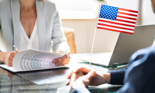 An immigration lawyer assisting a client with an immigration application.