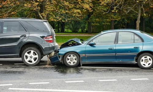 Two vehicles on a rainy day involved in a rear-ender accicent.