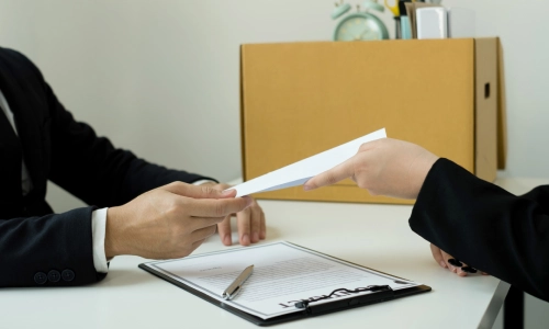 A Delhi personal injury lawyer handing legal documents to her client during a consultation.