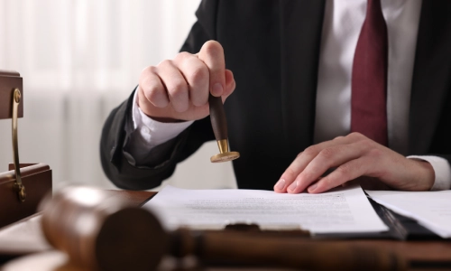 A Dangerous Drugs Lawyer holding a seal on top of some documents in a San Antonio law office