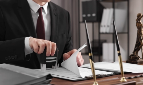 A Greenacres Personal Injury Lawyer notary stamping case files in his law office.