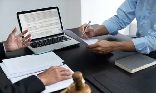 A Pinedale personal injury lawyer presenting a client’s case to a fellow legal team member to discuss potential strategies and get professional insight.