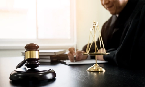 A Strathmore Personal Injury Lawyer sitting at their desk in a Strathmore law office while writing some notes