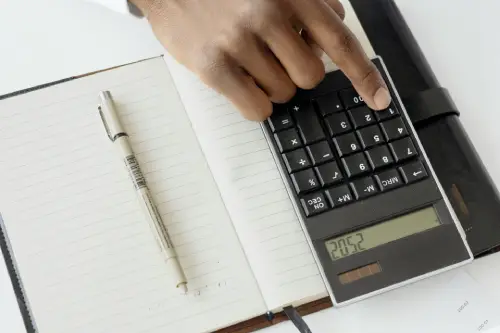 Calculating a car accident settlement amount using financial documents and a calculator