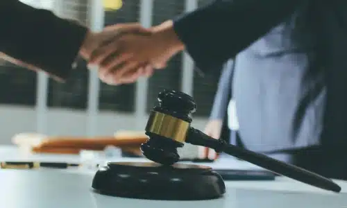 A California truck accident lawyer shaking hands with a colleague after successfully handling a truck accident case