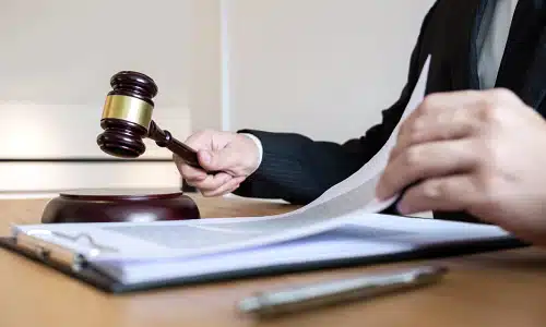 A rideshare accident lawyer is going through the pages of a legal document attached to a clipboard