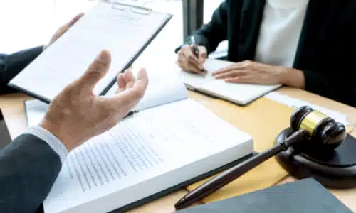 A Texas hit and run accident lawyer discussing case details with a colleague sitting at the opposite side of a table