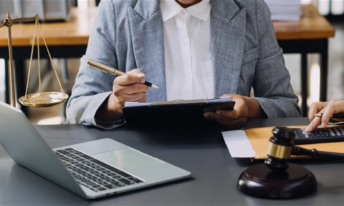 A truck accident lawyer sitting in a law office and discussing case details with a colleague