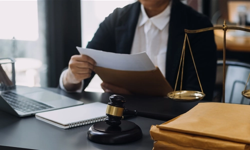 A workplace injury lawyer opening an envelope and pulling out the contents